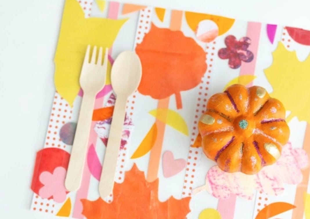 Colorful placemat with a small painted pumpkin and utensils